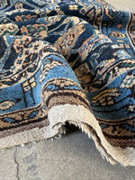Folded view showing weight and thickness of rug.