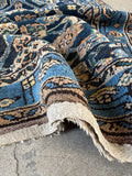 Folded view showing weight and thickness of rug.