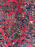 Allover floral design on red ground antique rug