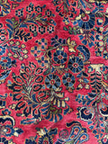 Allover floral design on red ground antique rug