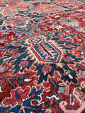 Hand knotted Persian Heriz rug. Large tribal wool rug with bold architectural design, full pile, and exceptional antique condition.