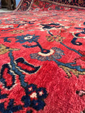 Authentic 100-year-old Persian carpet displaying traditional craftsmanship and vegetable-dyed wool texture.