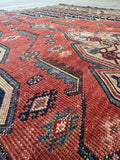 Rust and navy Persian area rug 4x6 display showing natural vegetable dye fading and low wool pile.