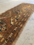 Hand-knotted vegetable dyed wool rug with traditional geometric medallions and intricate dark blue borders.