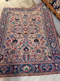 Antique Persian Heriz rug 1920s full view showing rare salmon ground and bold navy blue border.