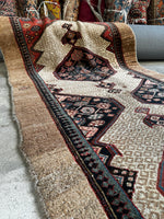 Handwoven Persian runner with turtle shell motifs.