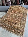 Antique Persian Tabriz rug by master weaver Haji Jalili featuring curvilinear floral design.
