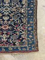 Corner view showing crimson wool woven on one end of the runner.