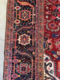 Close up view of intricate border band design on a vintage Persian rug.