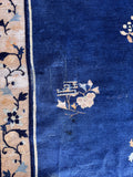 Hand-knotted blue wool area rug detail highlighting the lustrous vegetable-dyed wool sheen and soft pile texture.