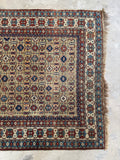 Antique Caucasian area rug with detailed border bands and nomadic weaving.
