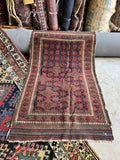 Persian Baluch rug close-up showing its striped flatwoven kilim end.