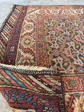 Underside view of antique Bakhtiari Persian runner, long hallway rug with vegetable dyed wool, geometric floral pattern, artisan weaving variations, and rich historic character.