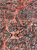 Hand Knotted Antique Persian Rug with a rare coral pink field, floral details, and naturally aged wool.