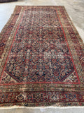 Hand knotted Persian Ferahan rug. Antique navy wool gallery carpet with dense floral Herati motifs and beautifully worn antique character.