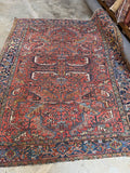 Antique geometric Persian rug. Hand knotted Heriz carpet with a terracotta field, midnight blue border, and healthy low pile in excellent antique condition.