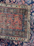 Handmade antique Persian wool rug with worn farmhouse character, low pile and vegetable dyed colors.