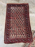 Vintage Persian scatter rug featuring repeating micro paisley boteh pattern on ivory field.
