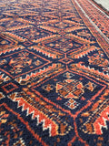 Hand knotted Baluchi accent rug close up shot illustrating vegetable dyed wool and amazing color story.