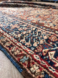 Antique Persian 5x7 rug displaying geometric poled medallions and surrounding floral symbols.