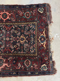 Dark teal antique Persian Malayer rug with shocks of pink and rich natural dyes.