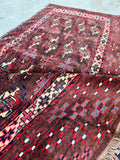 Persian Yomut bag face detail shot showcasing the fine hand-knotted weave, soft wool pile, and tribal symbols.