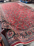 Oversized antique rug in pristine condition, woven with traditional vegetable-dyed wool and intricate florals.