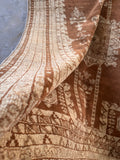 Neutral antique area rug showing tonal shifts in light across hand spun brown wool fibers.