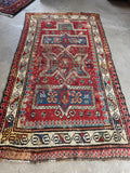 Worn antique tribal prayer rug with geometric mihrab, handmade wool rug full of character and history.