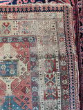 Vintage Caucasian area rug showing authentic color abrash and late 19th-century hand-knotted craftsmanship.