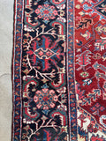 Vintage Heriz rug. Hand knotted Persian wool carpet with geometric medallion, unusual border medallions, and rich natural dyes.