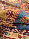 Antique Persian textile art piece featuring rare yellow wool, aqua accents, and symbolic tribal designs.
