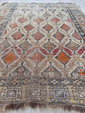 Caucasian tribal rug detail showing small-batch vegetable dyed wool and unique color variations.
