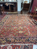 Large antique Persian Mahal rug with brick red field, floral motifs, natural abrash and floppy handle.