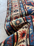 Antique Kazak rug with eight pointed stars symbolizing happiness and fertility.