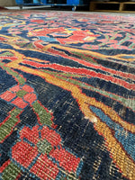 Close up detail showing rich red, blue, and gold vegetable-dyed wool.