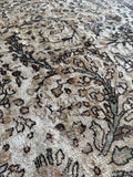 Close-up of curvilinear floral sprays on warm wheat background.