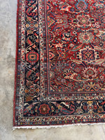 Corner view showing border of Mahal rug featuring floral and vine motifs.