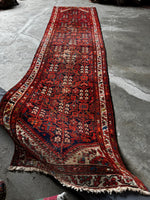 Bold red and ivory patterns guiding the path along the runner.