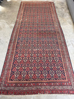 Long 16-foot Persian rug with intricate allover design on a navy blue ground.