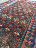 Antique Persian runner with espresso brown ground, coral, teal and indigo vegetable dyed wool.