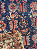 Underside of an antique Persian wool rug hand woven with vegetable dyed wool.
