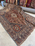 Nomadic Shiraz rug handwoven with vegetable-dyed wool in earthy tones.