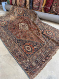 Nomadic Shiraz rug handwoven with vegetable-dyed wool in earthy tones.