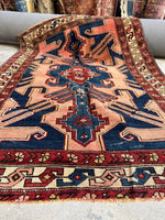 Close-up of fierce tribal medallion design on Persian rug.
