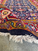 Vibrant natural dyes highlight the design of this Persian scatter rug.