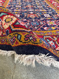 Vibrant natural dyes highlight the design of this Persian scatter rug.