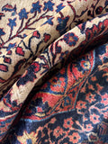 Hand-knotted ivory wool area rug macro detail highlighting the dense, heavyweight pile and rich wool texture.