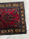Antique wool accent rug detail highlighting hand-knotted construction and durable edge binding.