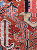 Mellowed plant dyed wool rug macro photo illustrating soft powder blue, cream, and rose pink accent colors against a rustic terracotta ground.